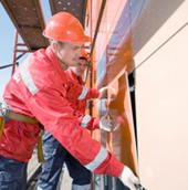 Промышленные альпинисты обшивают жилой дом панелями